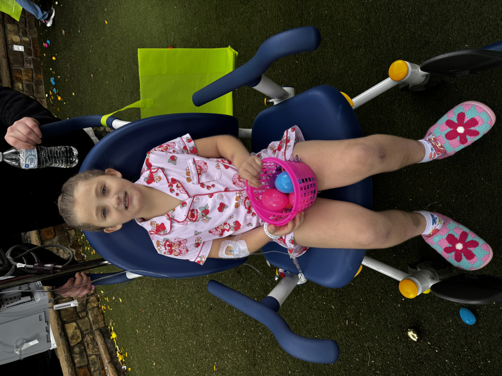 Hero Saylor Peugh smiling in a Gamerosity superhero cape